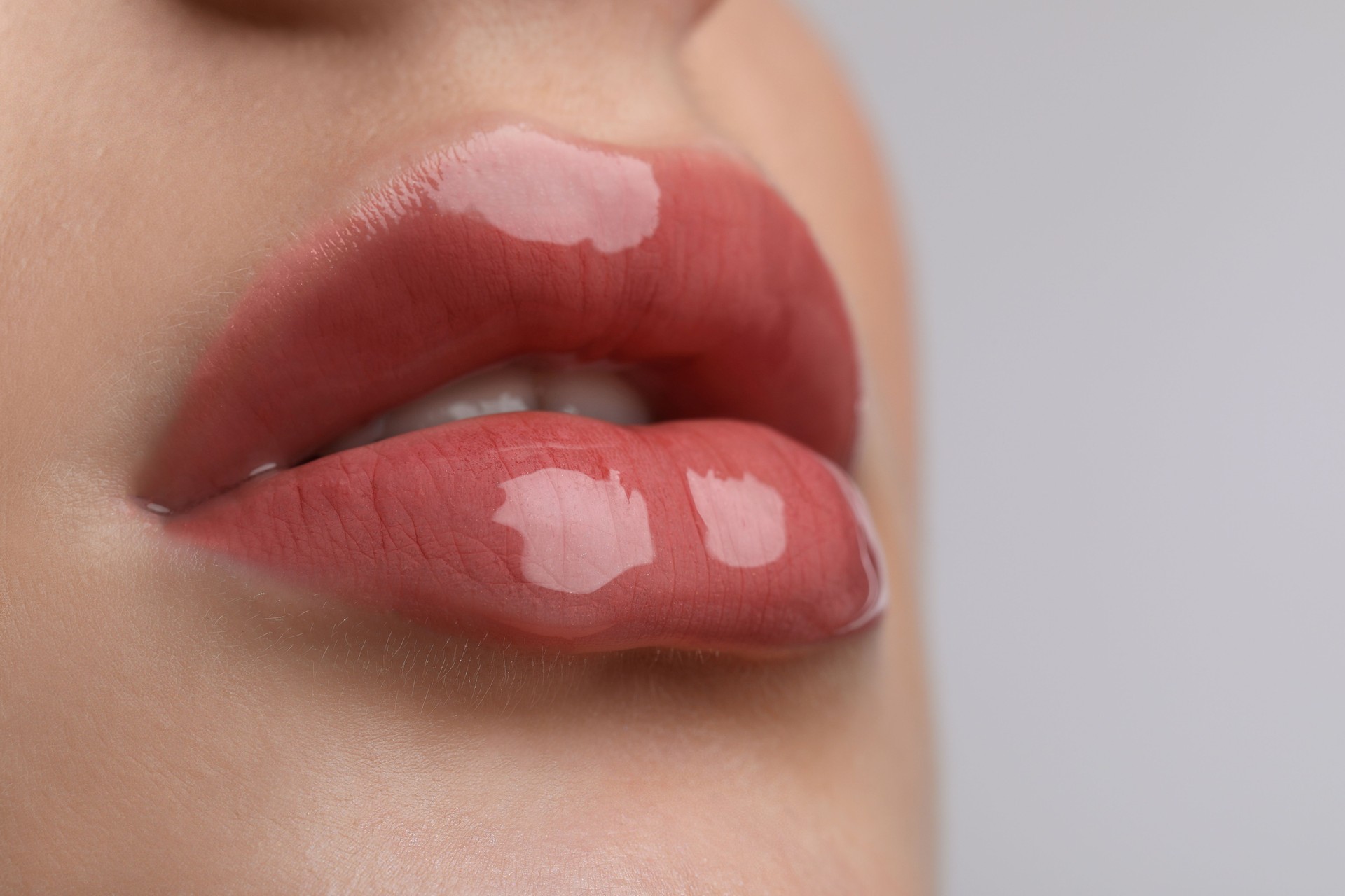Closeup view of beautiful young woman with perfect lips makeup on light grey background